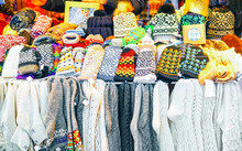 Knitted Socks And Mittens Souvenirs On Stalls At Christmas Market In Riga Of Latvia Winter. Europe. Street Xmas And Holiday Fair In European City Or Town. Advent Decoration With Crafts Items On Bazaar