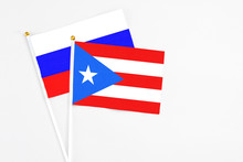 Puerto Rico And Russia Stick Flags On White Background. High Quality Fabric, Miniature National Flag. Peaceful Global Concept.White Floor For Copy Space.