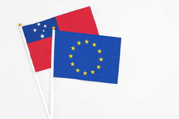 Canvas Print - European Union and Samoa stick flags on white background. High quality fabric, miniature national flag. Peaceful global concept.White floor for copy space.