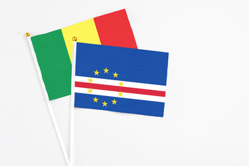 Cape Verde and Senegal stick flags on white background. High quality fabric, miniature national flag. Peaceful global concept.White floor for copy space.