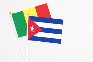 Cuba and Senegal stick flags on white background. High quality fabric, miniature national flag. Peaceful global concept.White floor for copy space.