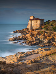 Wall Mural - sunset and golden lights on the coast and old castle in Livorno in Tuscany in Italy