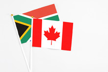 Canada And South Africa Stick Flags On White Background. High Quality Fabric, Miniature National Flag. Peaceful Global Concept.White Floor For Copy Space.