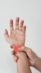 Wall Mural - Hand anatomy with red highlight on wrist pain. Wrist pain may cause from muscle strain, tendinitis, ligament sprain, arthritis, nerve entrapment or carpal tunnel syndrome disease. medical symptom