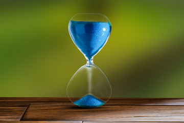 hourglass and green blur background