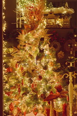 Closeup of white bauble hanging from decorated Christmas tree with bokeh, copy space, Christmas holiday background.Two thousand twenty. 2020