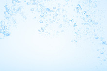 Bubbles In Blue Water Against A White Background