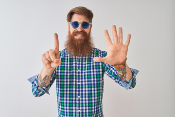 Poster - Young redhead irish man wearing casual shirt and sunglasses over isolated white background showing and pointing up with fingers number six while smiling confident and happy.