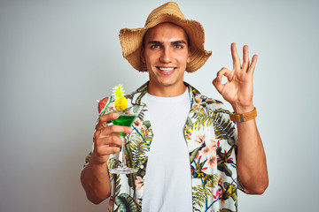 Poster - Young handsome man drinking cocktail on holiday over white isolated background doing ok sign with fingers, excellent symbol