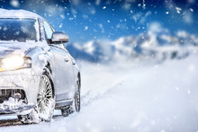 Luxury Car On Winter Road, Blur Mountains Background. Tires On Snow Highway.