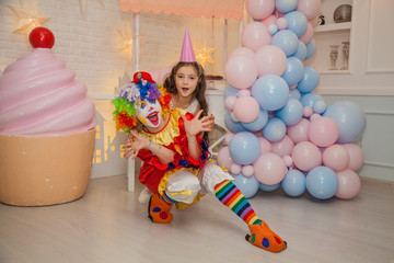 Wall Mural - Clown girl from the circus at the birthday party. Girl and the clown. Party for children.