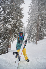 Wall Mural - smiling  snowboarder at ski resort in the mountain