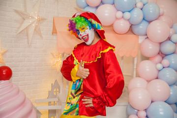 Wall Mural - Cheerful circus clown shows emotions of the holiday