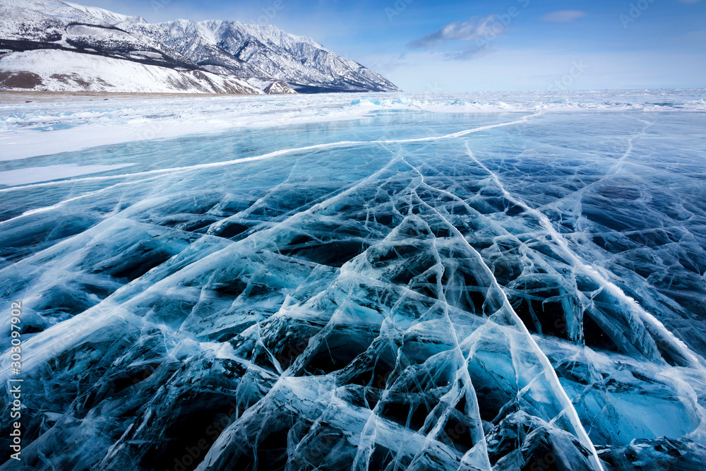 View of beautiful drawings on ice from cracks and bubbles of deep gas on surface of Baikal lake in winter, Russia - obrazy, fototapety, plakaty 
