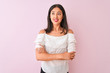 © Krakenimages.com - Beautiful chinese woman wearing white t-shirt standing over isolated pink background smiling looking to the side and staring away thinking.
