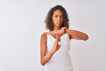 Canvas Print - Young brazilian woman wearing casual t-shirt standing over isolated white background Doing time out gesture with hands, frustrated and serious face