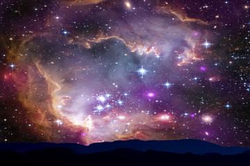 Wall Mural - blur nebula and galaxy back on night sky silhouette mountain