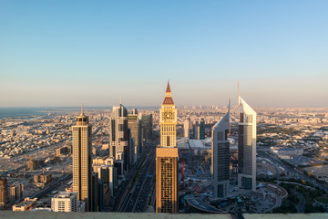 Canvas Print - Aerial view of the iconic Sheikh Zayed road Skyscrapers and landmarks - Aerial view of Dubai city roads and Towers at sunset - Gevora Hotel view