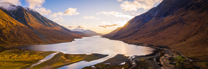 Wall Mural - aerial panorama of glen etive and loch etive in the argyll region of the highlands of scotland during autumn and a golden sunset