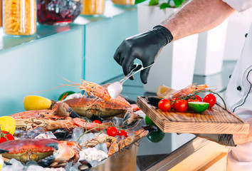 Wall Mural - The Chef puts the seafood on a tray in the restaurant.