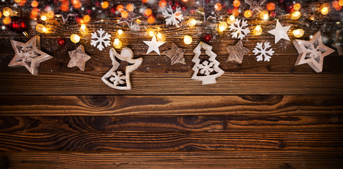 Wall Mural - Christmas background with wooden decorations and spot lights.