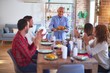 © Krakenimages.com - Beautiful family smiling happy and confident. Showing roasted turkey and applauding celebrating Christmas at home