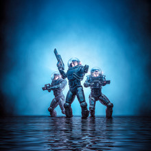 Search Party Patrol / 3D Illustration Of Science Fiction Scene Showing Heroic Space Marine Astronauts With Laser Pulse Rifles In Dark Watery Environment