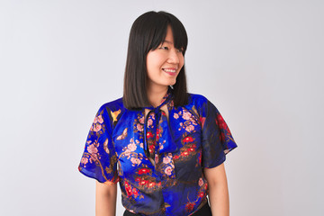 Wall Mural - Young beautiful chinese woman wearing summer floral t-shirt over isolated white background looking away to side with smile on face, natural expression. Laughing confident.