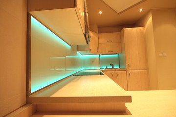 Modern luxury kitchen with custom made furnishings and LED RGB backlit glass