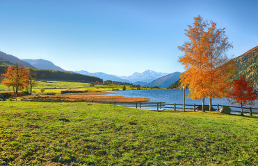 Splendid autumn panorama of Haidersee (Lago della Muta) lake with Ortler peak on backgroun