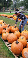 teen girl in a pumpkin patch on a farm in ohio