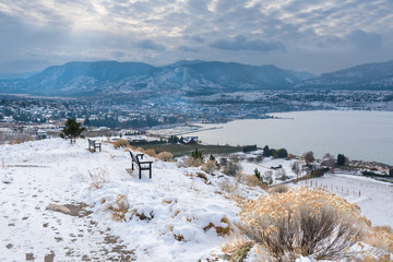 Winter view of Penticton covered in snow with view of Okanagan Lake and mountains