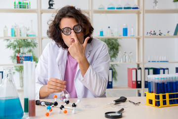 Funny male chemist working in the lab