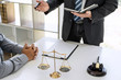 © Freedomz - Male lawyer or Counselor working in courtroom have meeting with client are consultation with contract papers of real estate, Law and Legal services concept