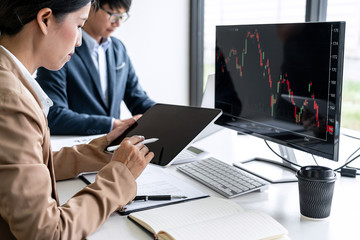 Poster - Business team partner working with computer, laptop, discussion and analyzing graph stock market trading with stock chart data planning, financial and investment concept