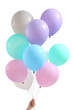 Female hand with balloons on white background