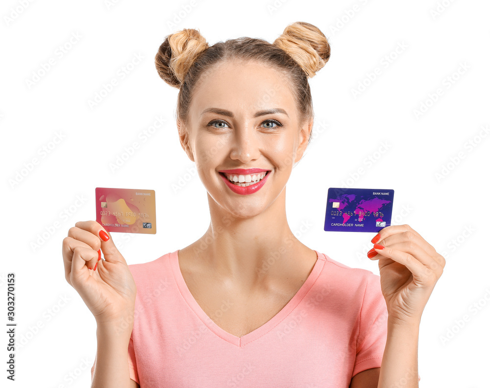 Young woman with credit cards on white background