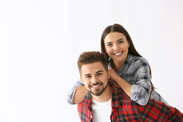 Wall Mural - Portrait of happy young couple on white background