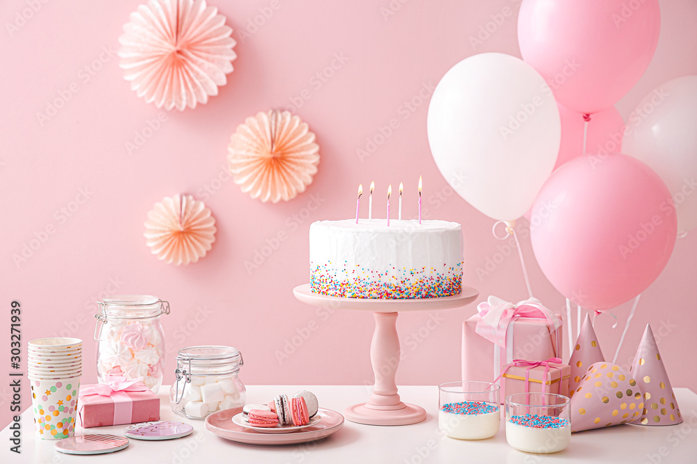Tasty candy bar for Birthday party on table against color background