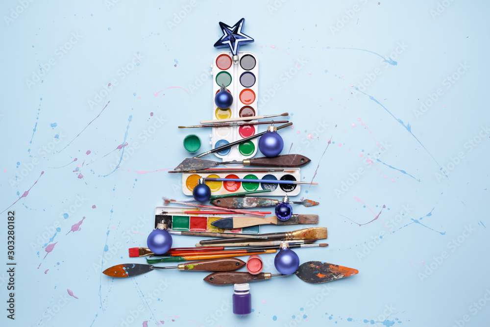 Obraz na płótnie Beautiful Christmas tree made of painter tools on color background w salonie