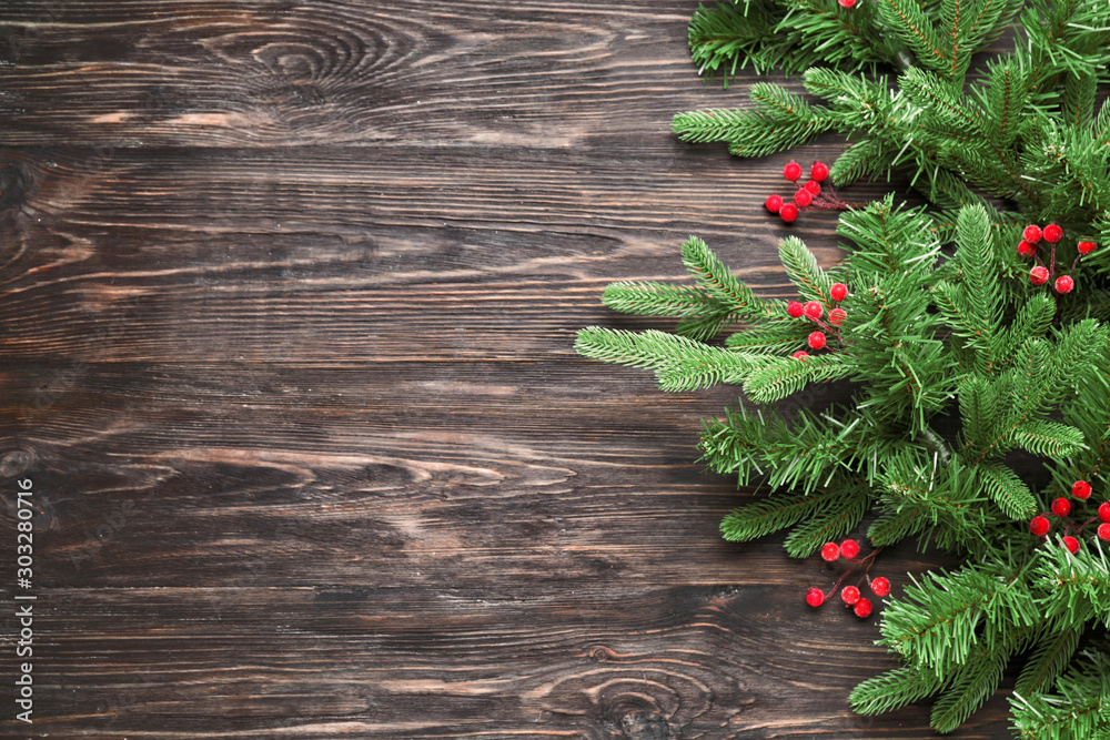 Beautiful fir branches on wooden background