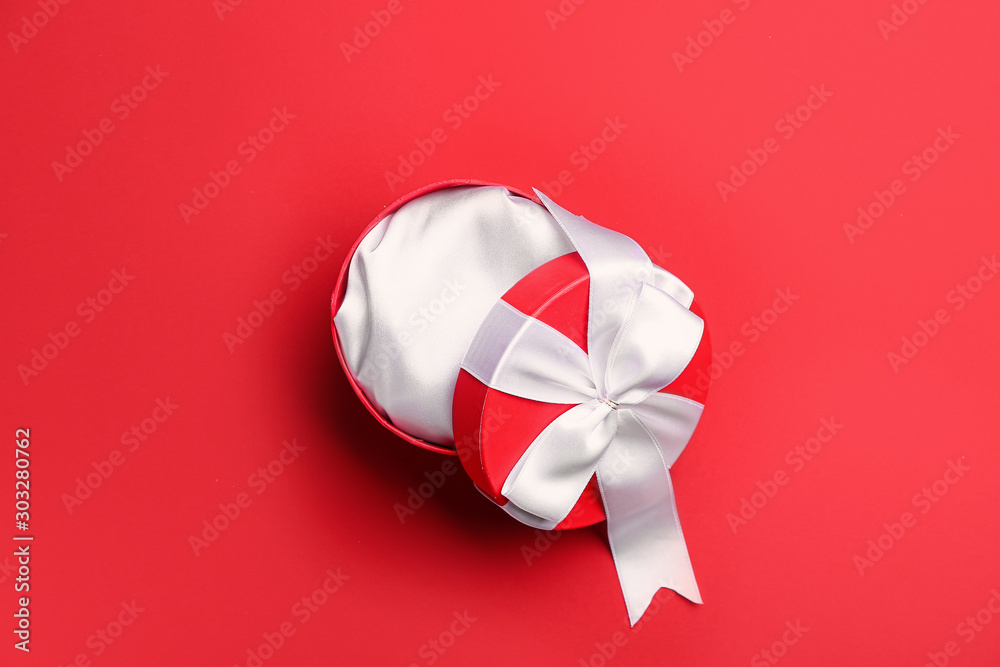Empty gift box for Valentine's Day on color background