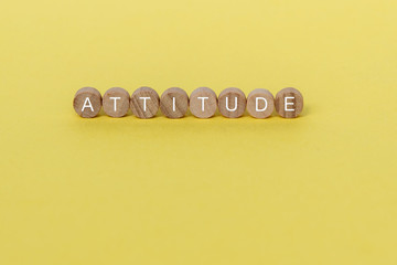 Wall Mural - Attitude text on wooden block on yellow background
