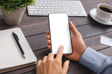 Poster - Unrecognizable man using modern smartphone with blank screen at workplace