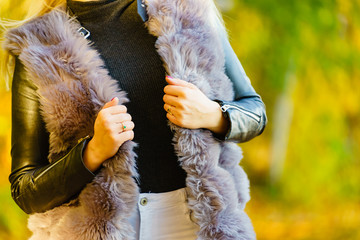 Woman wearing fur long vest during autumn