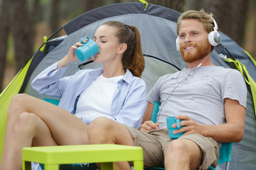 a young couple outside tent