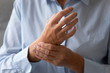 Senior lady massaging hand suffering from rheumatoid arthritis concept, closeup