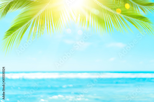 Blur beautiful nature green palm leaf on tropical beach with bokeh sun light ...