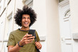 © mimagephotos - Close up happy young man holding mobile phone