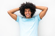 © mimagephotos - handsome young man with afro hair smiling with hands behind head against white background